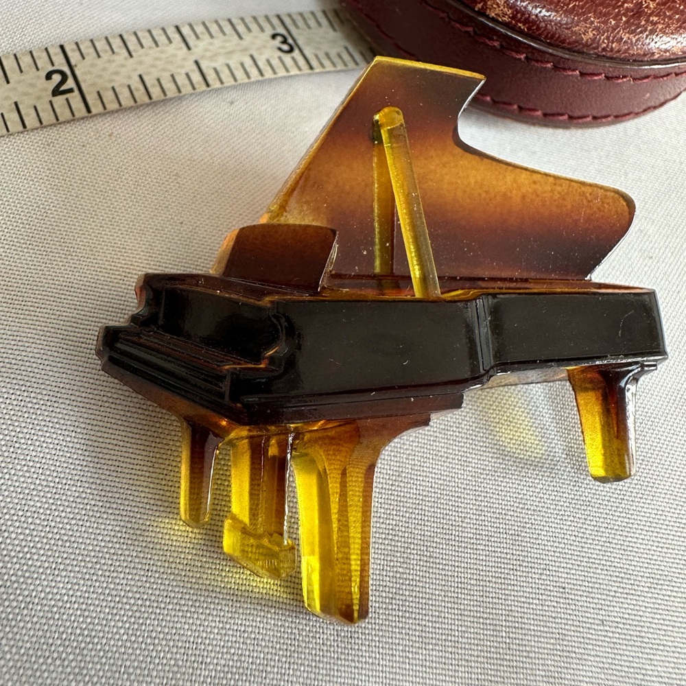 Vintage celluloid grand piano brooch